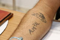 社章は、アレッサンドロ氏の右腕にもタトゥーとして刻まれている。