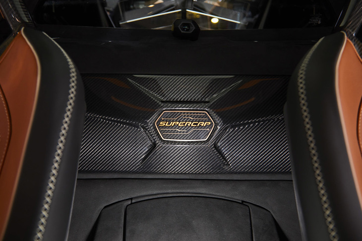 一般的にハイブリッド車に用いられるバッテリーの代わりに「シアンFKP 37」では、スーパーキャパシタを採用。リアのバルクヘッドには、それを示すロゴ入りカーボンパネルが設置されている。