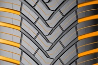 トレッド面では、やや太いV字型の溝が特徴的（黄色いカラーリングは機能・デザイン説明用のもの）。