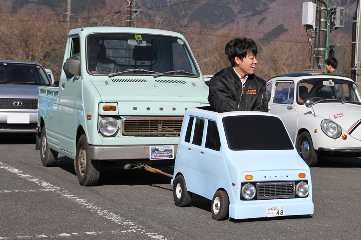 「ホンダ・ライフステップバン」（？）にけん引されて会場入りする「ライフピックアップ」。ステップバンの中身は電動カートだが、EVだけに意外なほどトルクがある。