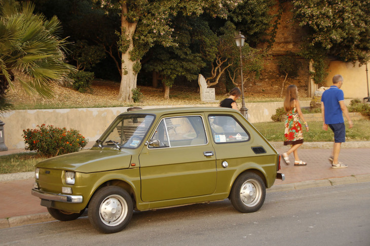 写真F。夕刻、ポルト・フェッライオの海岸通りに現れて注目を浴びていた「フィアット126」。