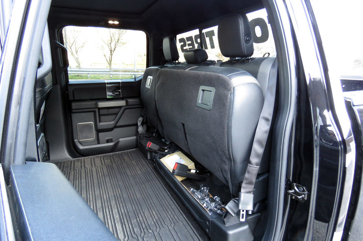 人が乗らないときには、座面を跳ね上げて荷室スペースとして使うことも可能。座面の付け根部分は収納スペースが設けられていて、テスト車にも洗車キットや工具などが積まれていた。