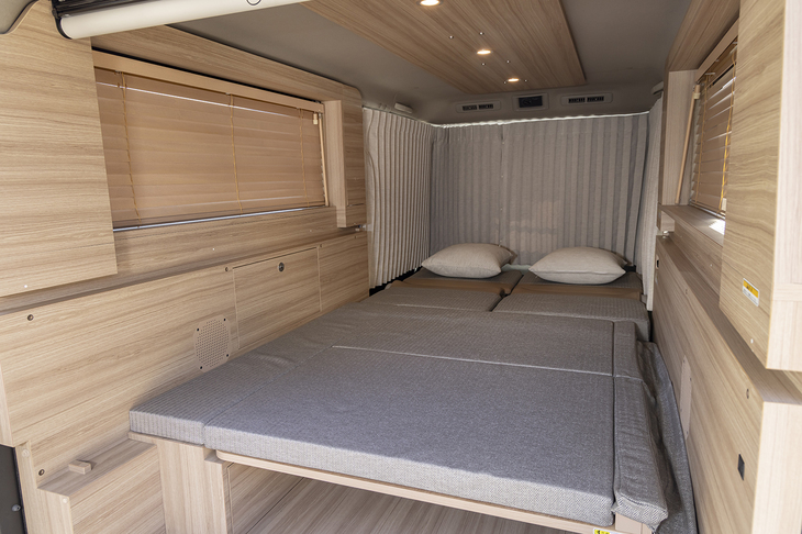 ベッドは組み立て式が標準で、右の壁に収納できる跳ね上げ式は17万6000円のオプション。ダンパーが組み込まれており、バタンと倒れてこないのは安心感がある。マットの質感も十分。