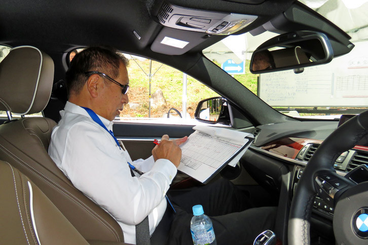 記者のドライビングを診断するモータージャーナリストの菰田 潔氏。ドライビングセミナー「BMW Driving Experience」では、チーフインストラクターを務めている。